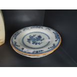 A 19th century Delft plate having traditional blue foliate decoration, an early 19th century pottery