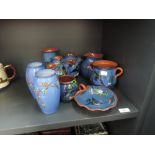 A selection of traditional Watcombe Torquay ware and a pair of blue enamelled vases