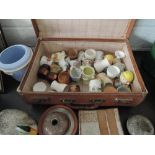 A vintage travel case containing selection of novelty egg cups and other ceramics including Fox of