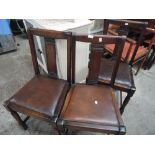 A siet of three mid 20th century oak dining chairs