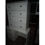 A modern white laminate dressing table and chest of drawers