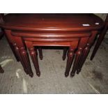 A modern mahogany effect nest of three tables