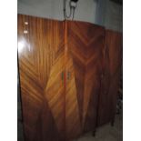 A mid 20th century walnut triple wardrobe