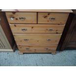 A modern pine chest of 2 over 3 drawers