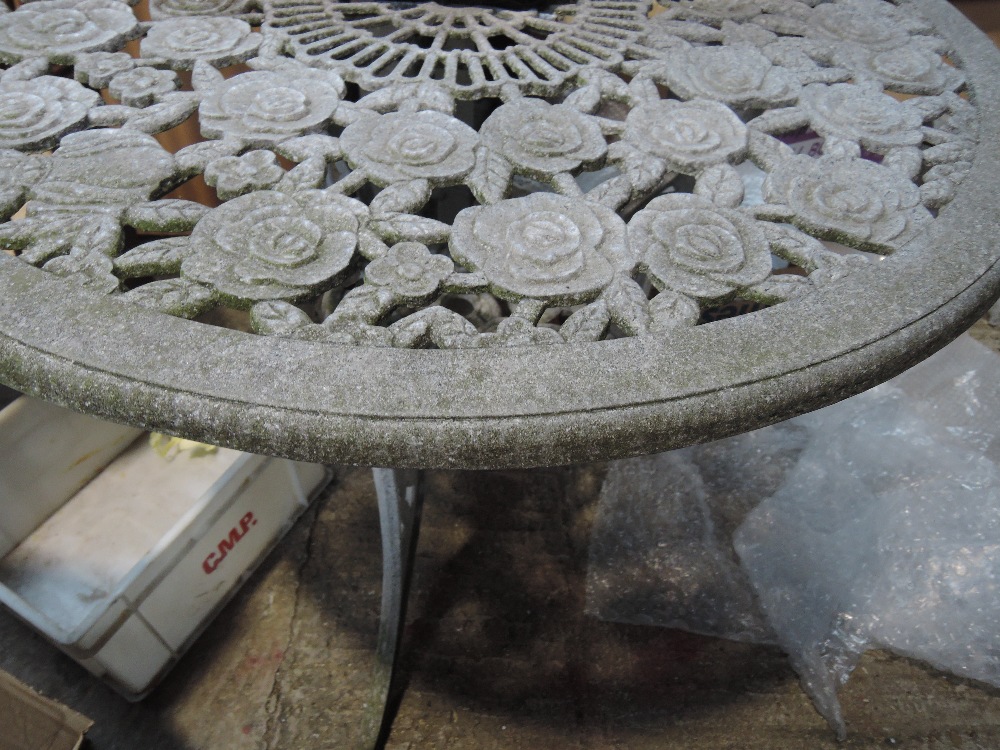A modern cast alluminium garden table
