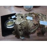 A set of four gilt metal curtain ties and a plated telescopic drinking cup in box