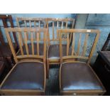 A set of four stained frame kitchen chairs