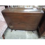 A mid 20th century oak drop leaf table