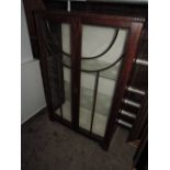 An early 20th century oak glazed display cabinet