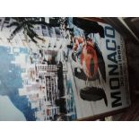 A vintage framed Monaco poster and several Formula One related prints including Senna