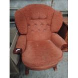 A modern rocking chair in terracotta uholstery