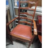An early 20th century oak frame ladder back carver chair