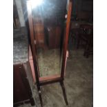 An early 20th century oak framed cheval mirror