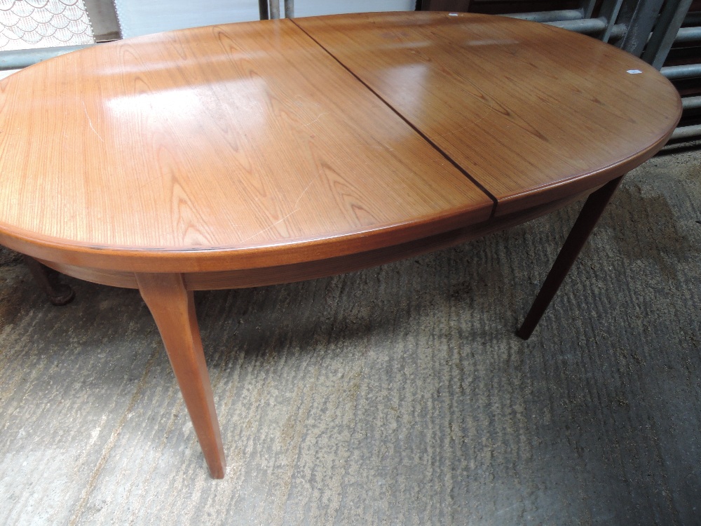 A 1970s style teak dining table