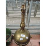 A vintage brass table lamp, possible modelled from depth charge/mine