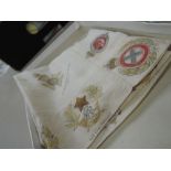 A vintage boxed handkerchief decorated with various military insignias AF