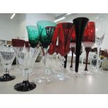 A selection of coloured glass, including champagne flutes, wine glasses and deco style cocktail