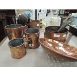 A selection of copper ware including grain measures, pans and ladles