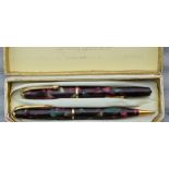 A Conway stewart red dinky 550 Fountain pen and pencil