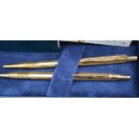 A Caren D'Ache gold plated ballpoint and pencil set