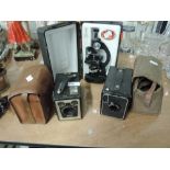 A Kodak Brownie Six-20 Model C camera, a Kodak Portrait Brownie No2 and Kiero microscope in case