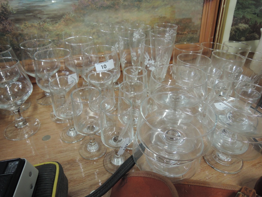 A selections of etched wine glasses and flutes etc