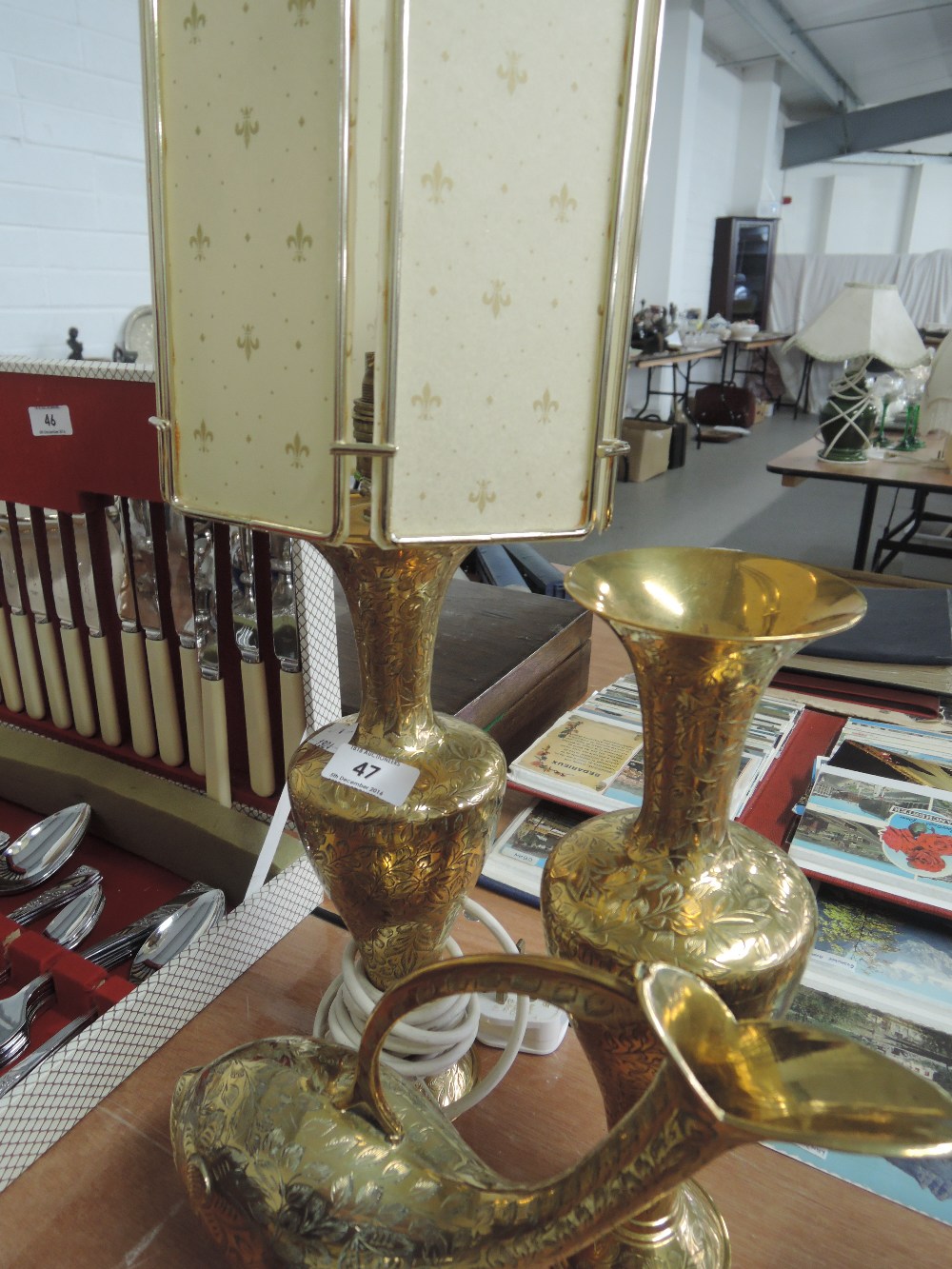 A pair of Indian brass vases, one in the form of a table lamp and a brass fish vase
