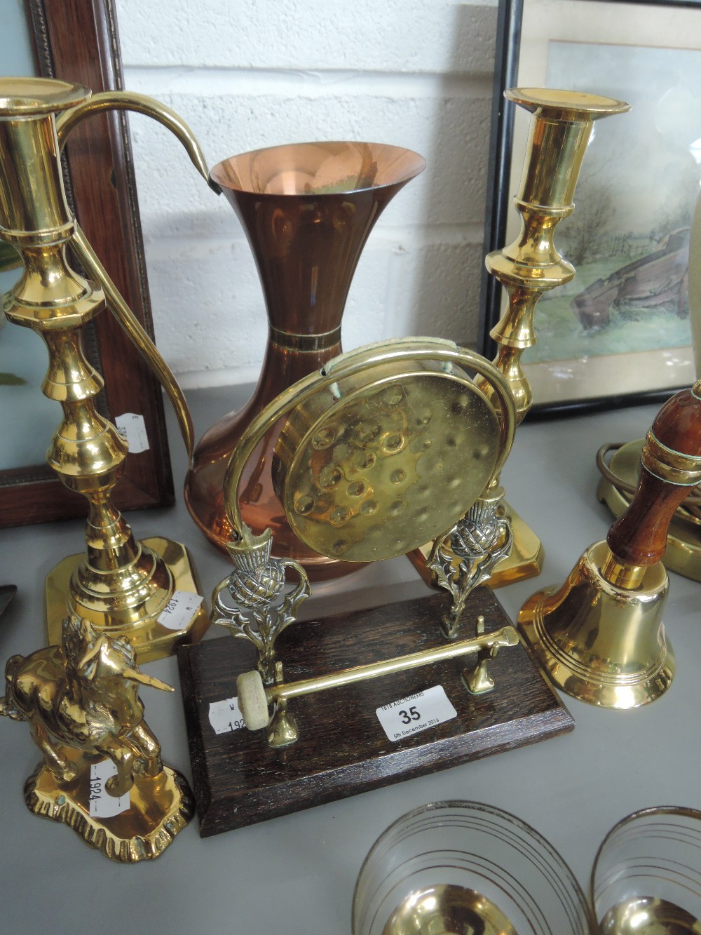 A selection of copper and brassware including candlesticks, dinner gong etc