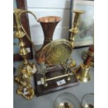 A selection of copper and brassware including candlesticks, dinner gong etc