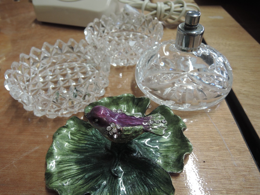 Two cut glass pin dishes, a cut glass perfume bottle and an enamel pin dish with bird decoration