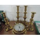 Two pairs of brass candlesticks and a brass wallclock