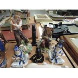 A selection of figurines including old man fishing and Indian dancers etc
