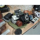 A selections of cameras, flashguns and lightmeters including a Kodak Brownie six-20, a Kodak