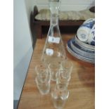 A conical decanter and glasses