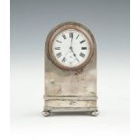 A SILVER CASED CARRIAGE CLOCK, Birmingham 1912, the arched case enclosing a white enamel dial with