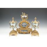 A FRENCH GILT METAL AND PORCELAIN MOUNTED THREE PIECE CLOCK GARNITURE, the clock surmounted by a