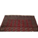 A MODERN TEKKE BACARA WOOL RUG, the centerfield woven with six rows of octagons divided by