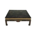 A CHINESE BLACK AND GILT LACQUERED SQUARE LOW OCCASIONAL TABLE, the top decorated with figural