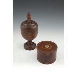 A VICTORIAN TREEN COVERED URN, with plain acorn finial above a bulbous body on pedestal foot, 25cm