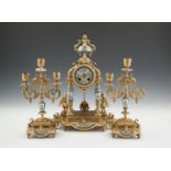 A FRENCH GILT METAL AND PORCELAIN MOUNTED THREE PIECE CLOCK GARNITURE, the clock surmounted by a