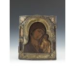 A RUSSIAN BRASS OVERLAID ICON, late 19th century, depicting Madonna and Child, oil on poplar