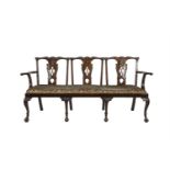 AN IRISH MAHOGANY TRIPLE CHAIR BACK SETTEE, 19th century, probably by Butler of Dublin, the raised