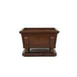 A GEORGE IV MAHOGANY WINE COOLER of sarcophagus form, the thumb moulded rim above beaded frieze,