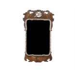 A 19TH CENTURY WALNUT AND PARCEL GILT WALL MIRROR IN MID-GEORGIAN STYLE, the shaped rectangular