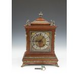 AN EDWARDIAN OAK CASED BRACKET CLOCK, with applied cast brass mounts