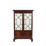 AN EDWARDIAN MAHOGANY WARDROBE of compact proportions, with dentil cornice above twin astragal