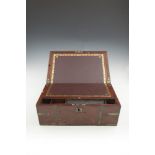 A VICTORIAN BRASS BOUND MAHOGANY RECTANGULAR LAP-DESK, the lid opening to reveal a tooled leather