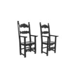 A PAIR OF BLACK STAINED TALL BACK OPEN ARMCHAIRS, with plank seats