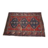 A CAUCASIAN KAZAK WOOL RUG, the large rectangular field woven with three interlinked lozenges filled
