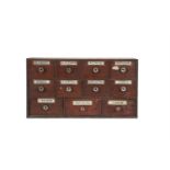 A STAINED WOOD APOTHECARY'S CABINET OF DRAWERS, fitted with eleven drawers with glass handles and